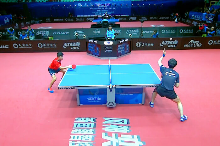 Kanak Jha (USA) with his racket over the table awaiting the service of Lee Sangsu (South Korea)