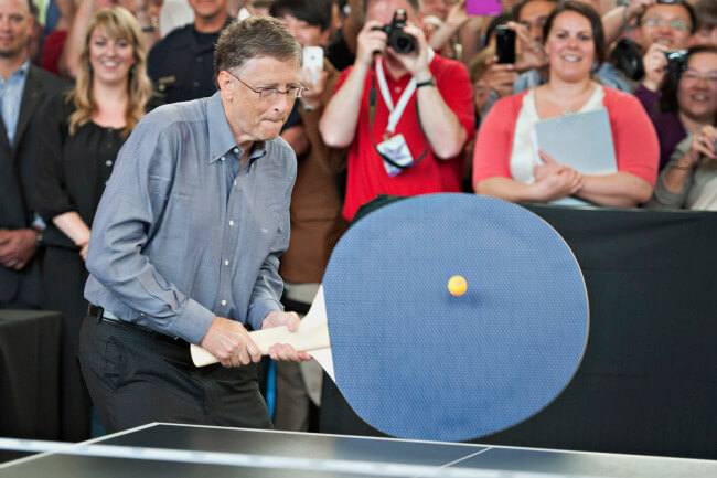 Bill Gates tries playing with a large racket